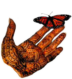 This is an nlargement of a monarch butterfly perched on a hand decorated with henna.
