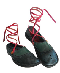 This is an enlargement of a pair of handmade shoes with red ankle ties.