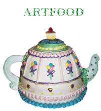 Photograph of a birthday cake made in the shape of a tea pot.
