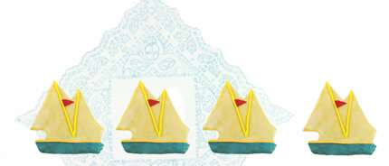 Photograph of four sailboat cookies.