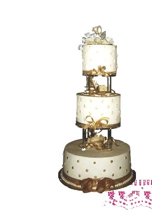 Photograph of a white and gold cake used for a wedding or anniversary.