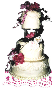 Photograph of three tiered wedding cake with a garland of silk flowers.