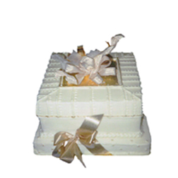 one of a display of package shaped wedding cakes frosted in white buttercream with edible gold