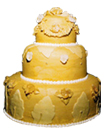 three tiered stacked wedding cake frosted in yellow to match bride's collection of vintage pottery